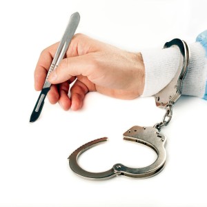 Doctor Holding Scalpel in Hand With Handcuff On